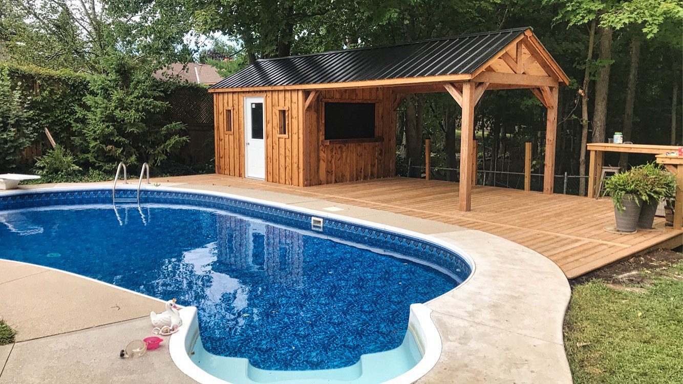 Pool bar with covered patio table and build in deck next to pool